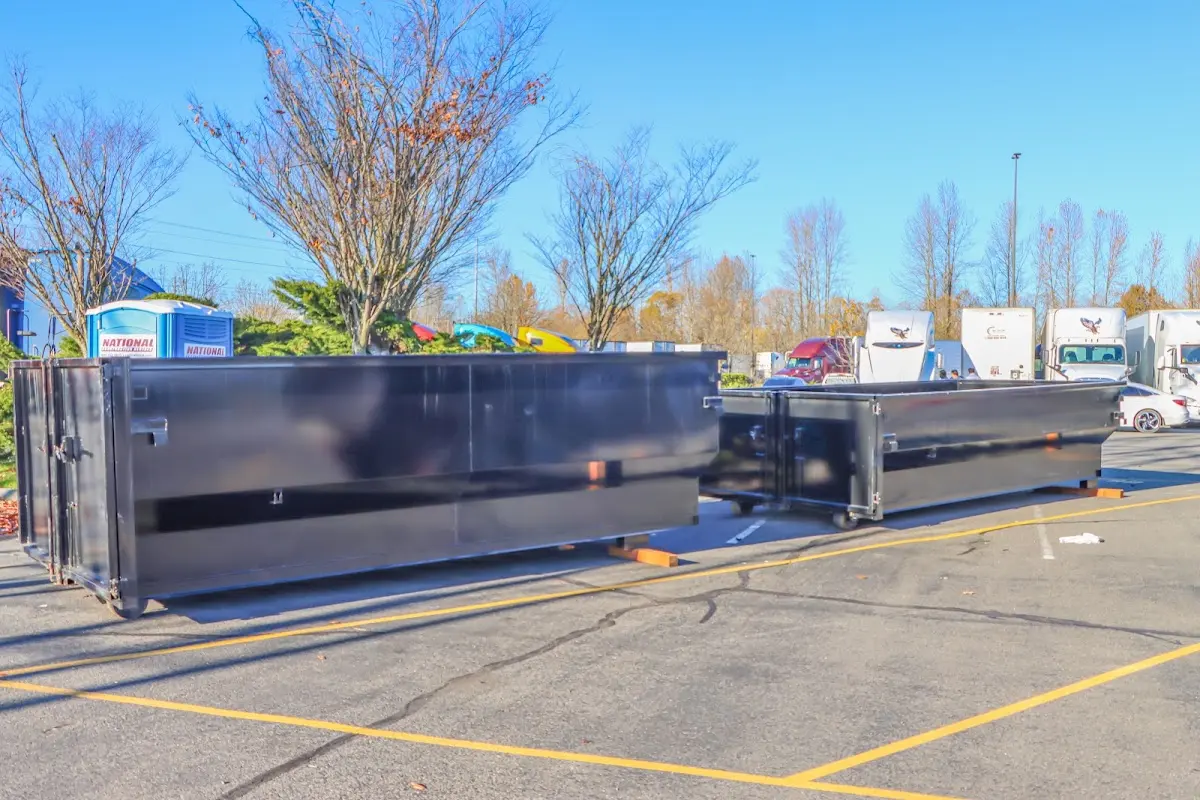 Professional dumpster rental service with roll-off container on residential driveway in Orion